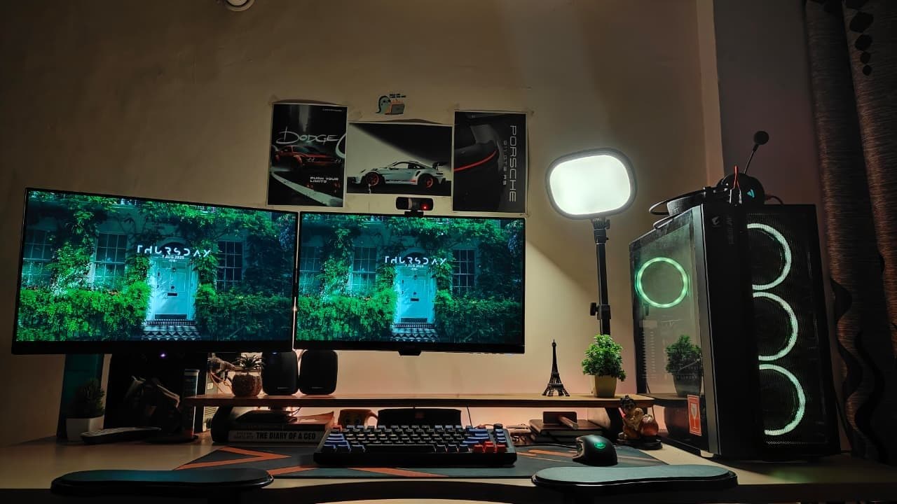 Harshit's desk setup with two monitors, a mechanical keyboard, and an RGB PC